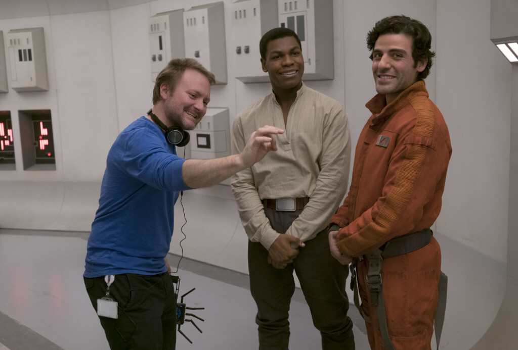 Star Wars: The Last Jedi..L to R: Director Rian Johnson on set with John Boyega (Finn) and Oscar Isaac (Poe Dameron)..Photo: David James..©2017 Lucasfilm Ltd. All Rights Reserved.