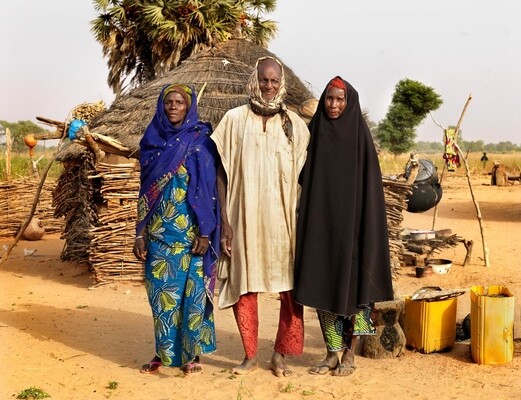 On 18 November 2015, Moussa Adamou, 92, grandfather of Karima,14, stands with his two wives in the village of Rougan Moussa Adamou in the district of Maradi. He is the eldest/representative in the village so the town is named after him. He was married when he was 37 years old. His parents had arranged a marriage with a girl from the village. But they did not love each other, so after a year he asked her if she would leave. She did. He found a woman whom he did love. They married and are still together. There was also a second woman. He has two wives, one is 80 years old and the other is 60 years old. HeÕs has ten children, of which 5 girls and 5 boys. UNICEF supports the Direction rgionale de la population, de la promotion de la femme et de la protection de lÕenfant de Maradi. (DRP/PF/PE). This is a partner organization of UNICEF that spoke to her grandfather. When her grandfather refused to cancel the marriage, they informed the chief of protection from the local authorities. He could cancel the marriage. UNICEF supports the organization technically, financially and with materials.