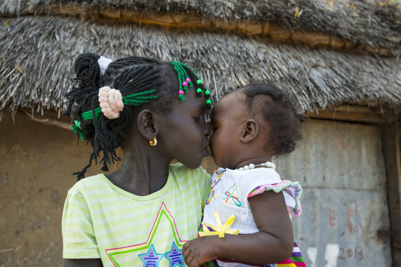 On 22 October 2015 in South Sudan, (left-right) Nyayjaw, 8, kisses her baby sister Nyagua whom she just met today, after being reunited with her mother. For two years, the family was separated by conflict. Nyayjaw and her brother Chuol, 4, have been living with their elderly grandfather in the Bor Protection of Civilians site. I will never allow us to be apart again, said their mother Nyaruon, after their tearful reunion in Akobo, their hometown. Then came the added joy, the introduction of the children to their newborn baby sister Nyagua whom they have never met before. Over 35,000 South Sudanese children have been separated from their families across the region since conflict broke out in December 2013. This includes over 11,000 children that have been registered as separated, unaccompanied or missing within the country. Multiple displacements, grave child rights violations and increasing food insecurity continue to separate children from their families. UNICEF South Sudan initiated a large scale family tracing and reunification programme, building on new and existing partnerships. By the end of 2015, UNICEF and its partners had been achieved the following: 11,400 children were registered, with family tracing ongoing; over 30 percent of these children were identified by UNICEF staff through direct implementation modalities; 3,600 children were reunited with their families; 12 partnerships were put into place to undertake family tracing and reunification in 29 counties; a national practice framework was put in place, including standard operating procedures and information sharing protocols; a quality framework has been developed to guide partners efforts to strengthen their responses. UNICEFs Family Tracing and Reunification programme is supported by the European Commission's Humanitarian Aid and Civil Protection Department (ECHO).