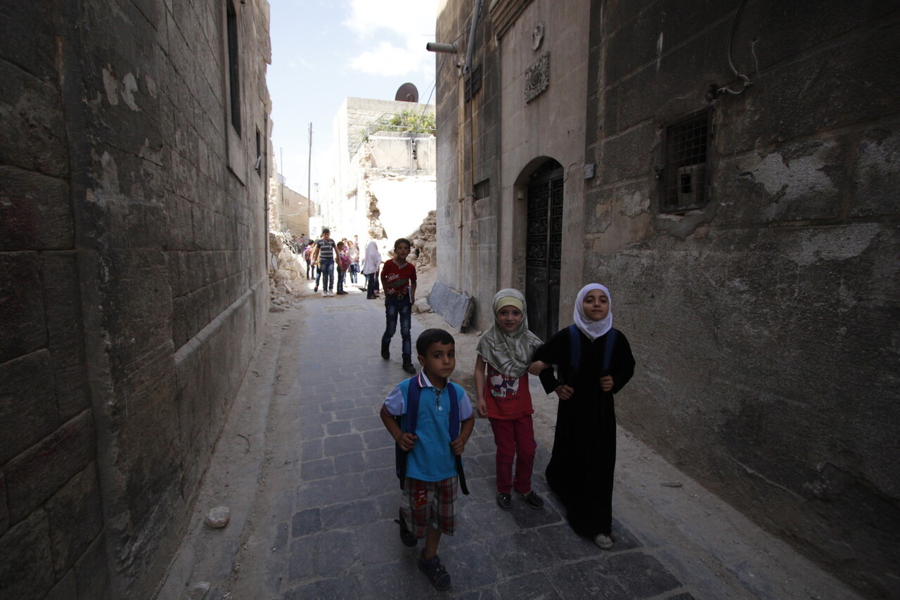 On 21 September 2016 in eastern Aleppo in the Syrian Arab Republic, Judy (white head scarf), 9, and her schoolmates return from the first day of school passing the rubble of nearby houses. I go to school every day, except for the times when I hear the planes, Judy explains. I want the road to reopen so I can go see my brother who lives in another city and just got married. I havent even met his wife yet, says Judy. Instead, the road remained closed due to heavy bombardment and shelling. In Judys neighborhood, electricity is largely unavailable as there is a fuel shortage. One in four schools are not functioning in the Syrian Arab Republic because they have been damaged, destroyed, or serve as shelters for displaced families or are in use for military purposes. Over two million children across the country are not able to go back to learning, while another 400,000 children are at risk of dropping out, due to heavy violence, lack of safe learning environments and displacement. More than 52,000 teachers have left their jobs. Two decades of investment in learning has been wiped out, as some children have lost up five years of their education, while others have never been to school. UNICEF is supporting more than 1,200 dedicated young volunteers to conduct a door-to-door campaign to map the numbers and situations of out-of-school children, while reaching out to parents with information about the simplified school enrollment processes and the right to have an education. Also recently launched is a back-to-learning campaign that aims to reach 2.5 million children in the country, including 154,000 living in besieged and hard-to-reach areas. UNICEF will be providing educational materials, school bags and stationery. A social mobilization campaign encourages parents to send their children to school or benefit from alternative learning opportunities where schools are no longer functioning. As part of that campaign, social media, radio and televi