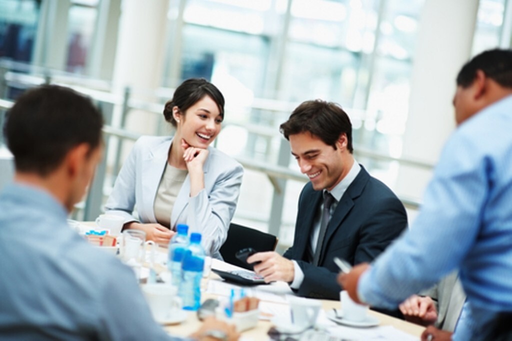 Smiling business executive sitting for a boardroom meeting