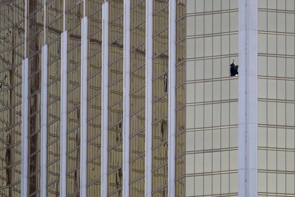 A broken window at the Mandalay Bay resort and casino is seen in the aftermath of a mass shooting on the Las Vegas Strip, Monday, Oct. 2, 2017, in Las Vegas. (AP Photo/Marcio Jose Sanchez)