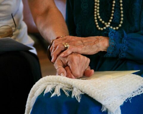 person wearing gold ring and blue dress